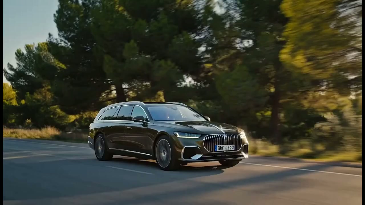 Dark green German estate car on a pine-lined road